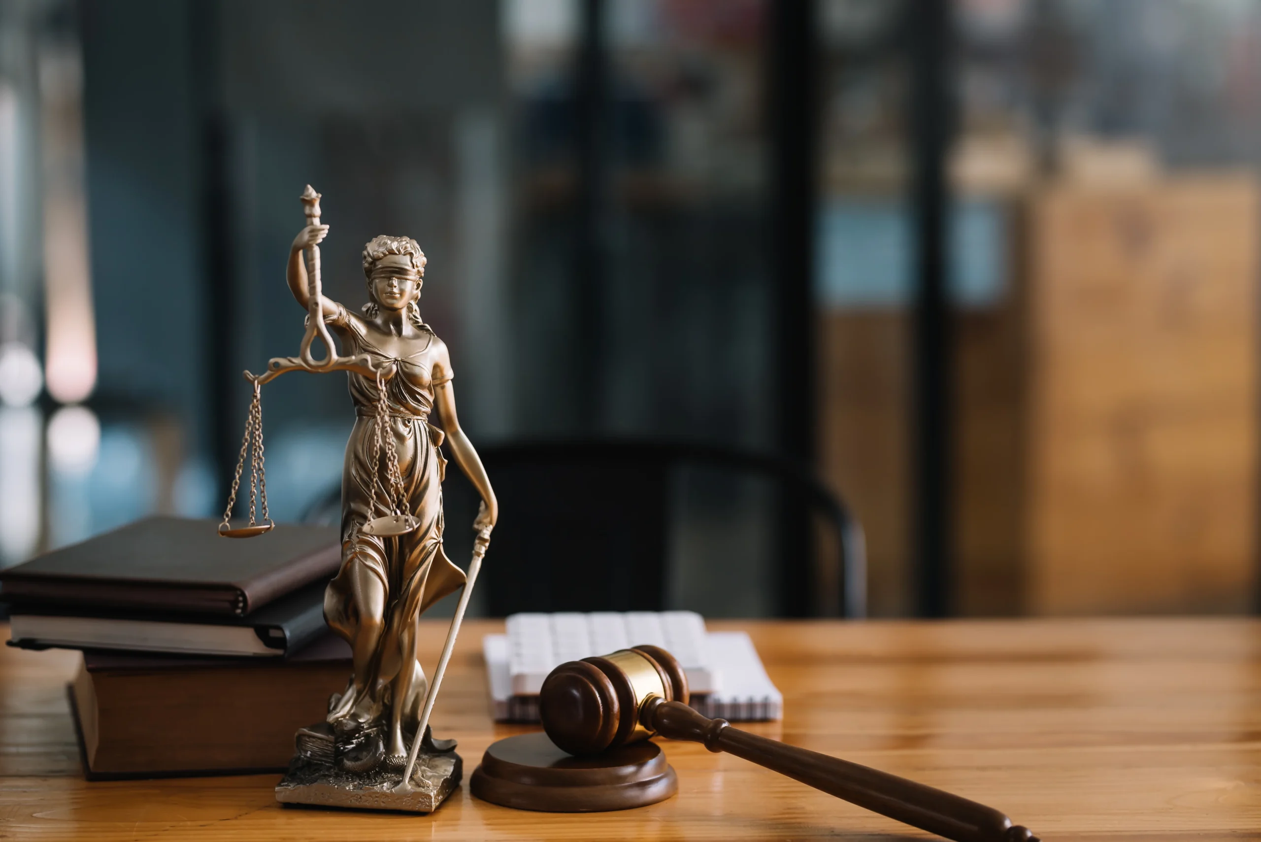 statue-of-lady-justice-on-desk-of-a-lawyer statue-of-lady-justice-on-desk-of-a-lawyer